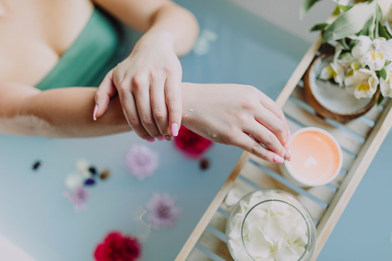 A serene spa experience with flowers, candles, and a relaxing bath. Perfect for self-care and relaxation.