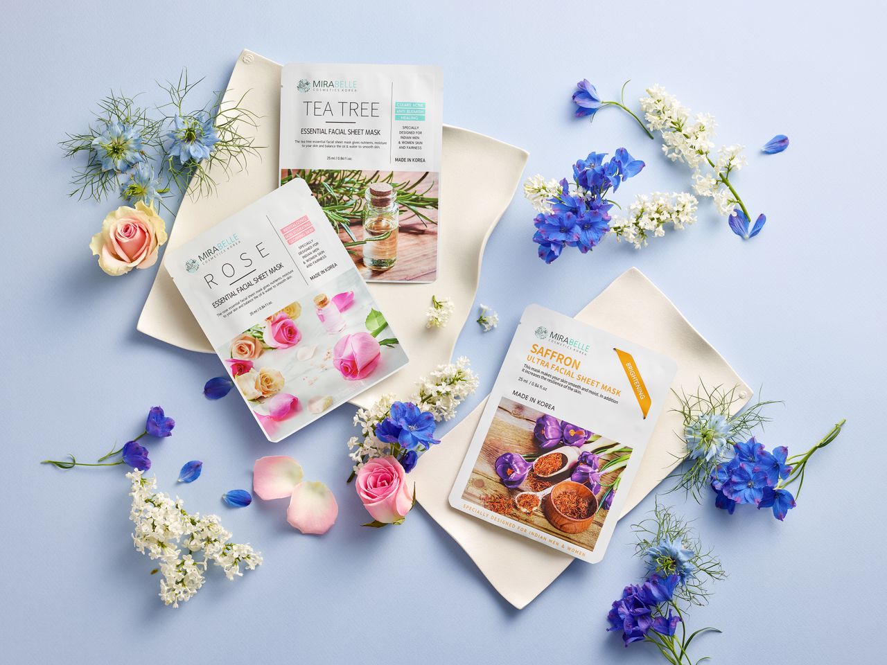 Beautiful floral arrangement with skincare face mask packaging on a blue background.